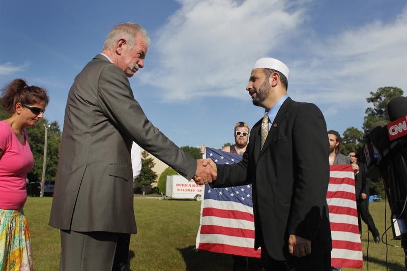 Dove World Outreach Center pastor Terry Jones (L) shakes hands with Imam Muhammad Musri, president of the Islamic Society of Central Florida in Orlando.